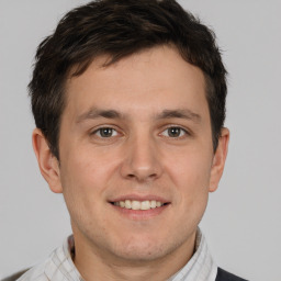 Joyful white adult male with short  brown hair and brown eyes