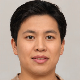 Joyful asian young-adult male with short  brown hair and brown eyes