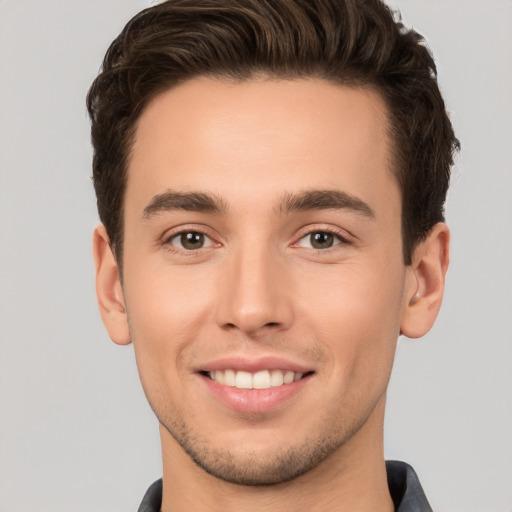 Joyful white young-adult male with short  brown hair and brown eyes