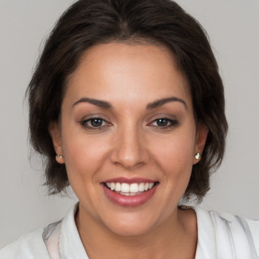 Joyful white young-adult female with medium  brown hair and brown eyes