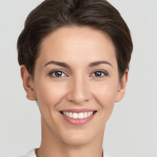 Joyful white young-adult female with short  brown hair and brown eyes