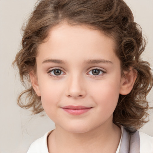 Joyful white child female with medium  brown hair and brown eyes