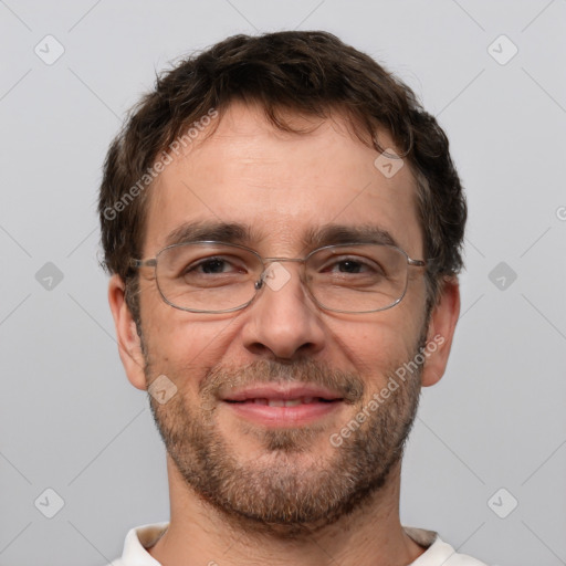 Joyful white adult male with short  brown hair and brown eyes