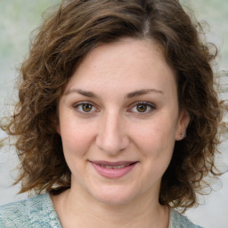 Joyful white young-adult female with medium  brown hair and green eyes