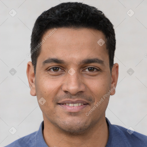 Joyful latino young-adult male with short  black hair and brown eyes