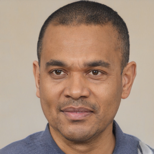 Joyful latino adult male with short  black hair and brown eyes