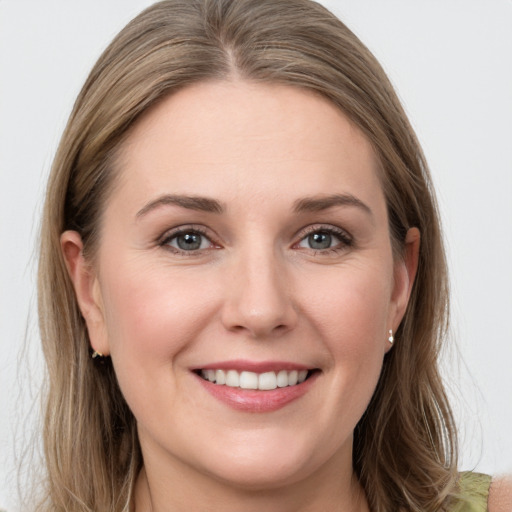 Joyful white young-adult female with long  brown hair and grey eyes