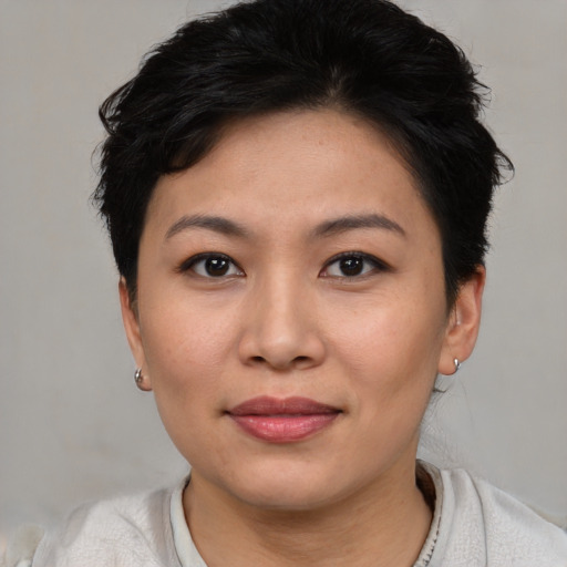 Joyful asian young-adult female with short  brown hair and brown eyes