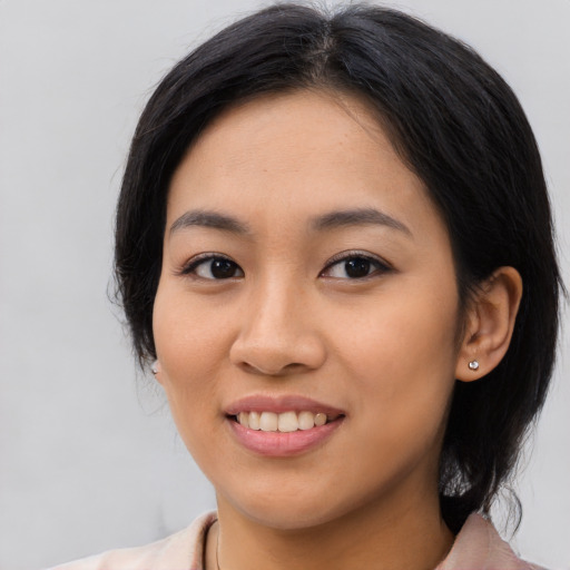 Joyful latino young-adult female with medium  black hair and brown eyes