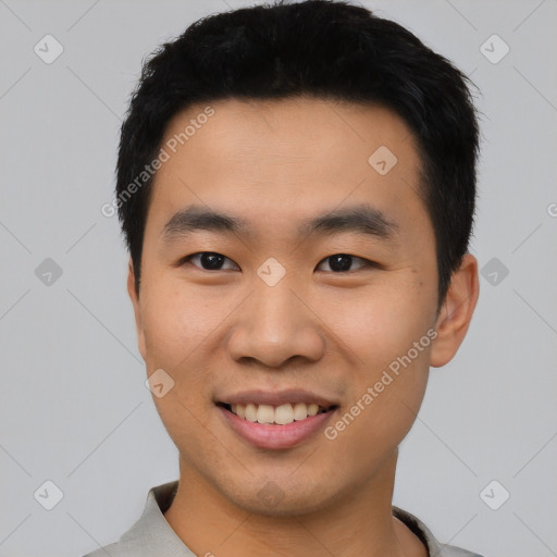 Joyful asian young-adult male with short  black hair and brown eyes