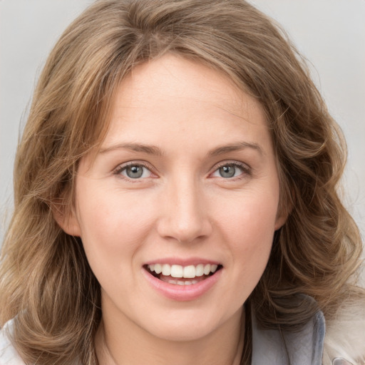 Joyful white young-adult female with medium  brown hair and green eyes