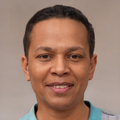 Joyful latino adult male with short  black hair and brown eyes