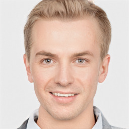 Joyful white young-adult male with short  brown hair and grey eyes