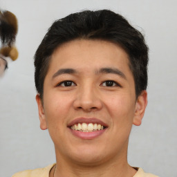 Joyful asian young-adult male with short  brown hair and brown eyes