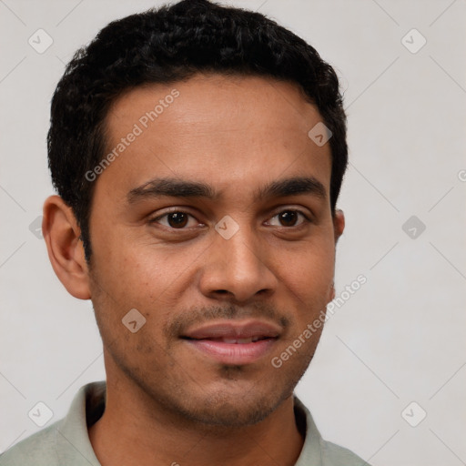 Joyful latino young-adult male with short  brown hair and brown eyes