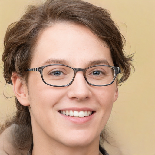 Joyful white young-adult female with medium  brown hair and blue eyes