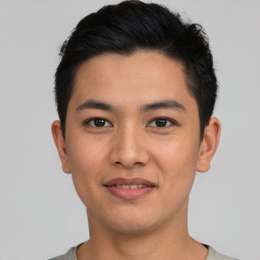 Joyful asian young-adult male with short  black hair and brown eyes