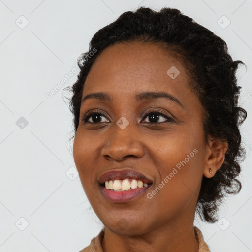 Joyful black young-adult female with long  black hair and brown eyes