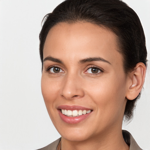 Joyful white young-adult female with medium  brown hair and brown eyes