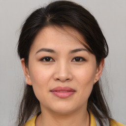 Joyful asian young-adult female with medium  brown hair and brown eyes