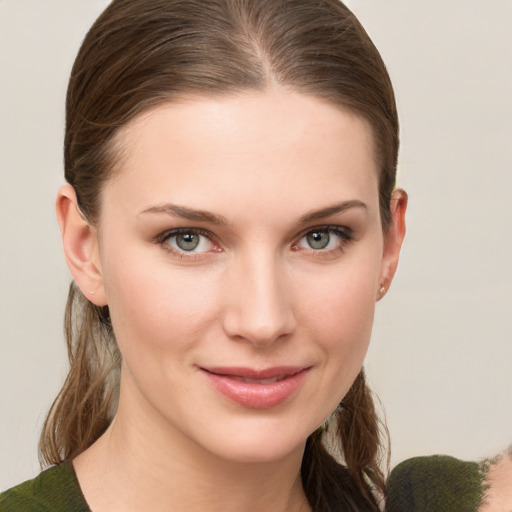 Joyful white young-adult female with medium  brown hair and grey eyes