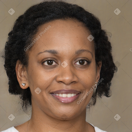 Joyful black adult female with medium  brown hair and brown eyes