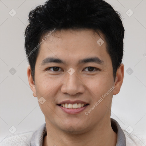 Joyful asian young-adult male with short  black hair and brown eyes