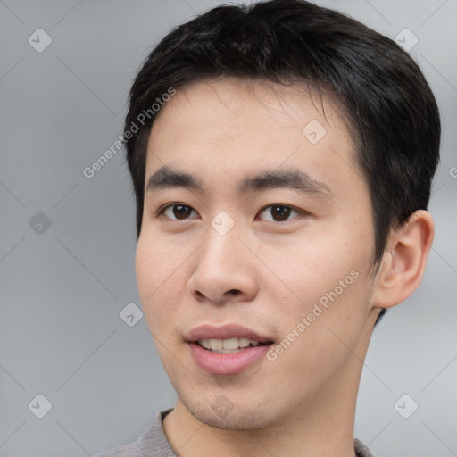 Joyful asian young-adult male with short  black hair and brown eyes