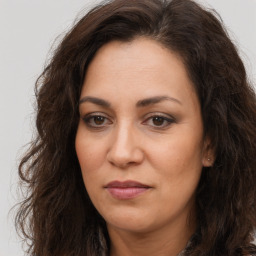 Joyful white adult female with long  brown hair and brown eyes