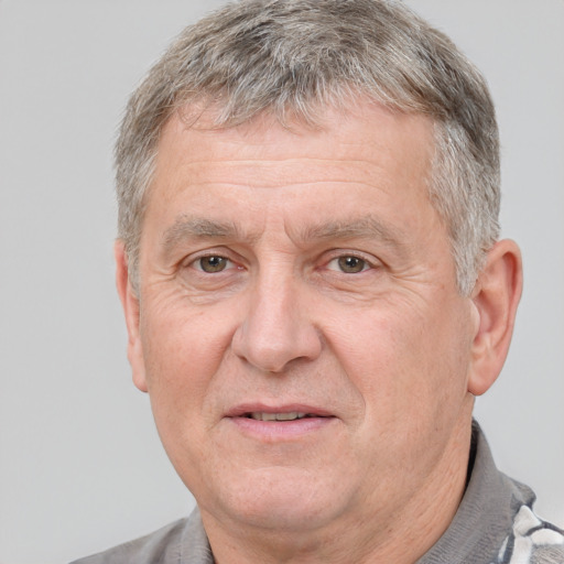 Joyful white middle-aged male with short  gray hair and brown eyes
