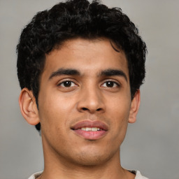 Joyful latino young-adult male with short  brown hair and brown eyes