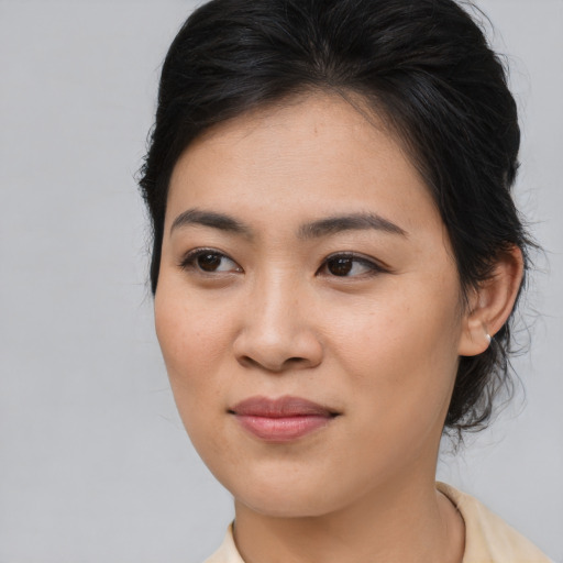 Joyful asian young-adult female with medium  brown hair and brown eyes