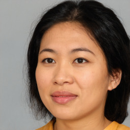 Joyful asian young-adult female with medium  black hair and brown eyes