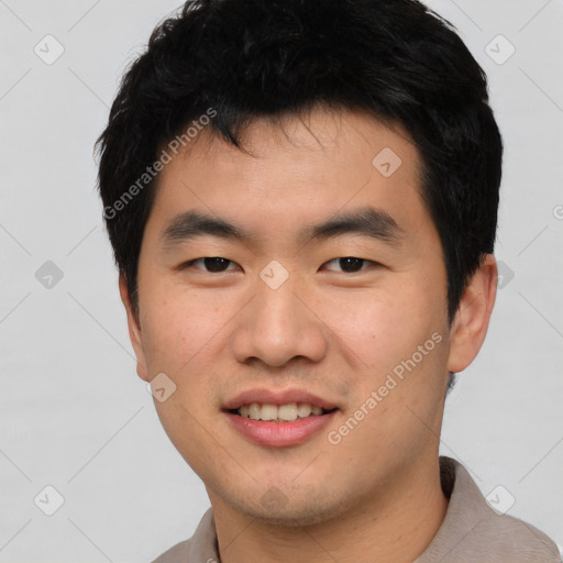 Joyful asian young-adult male with short  black hair and brown eyes