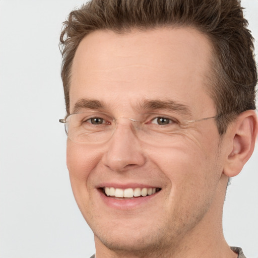 Joyful white adult male with short  brown hair and brown eyes