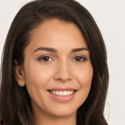 Joyful white young-adult female with long  brown hair and brown eyes