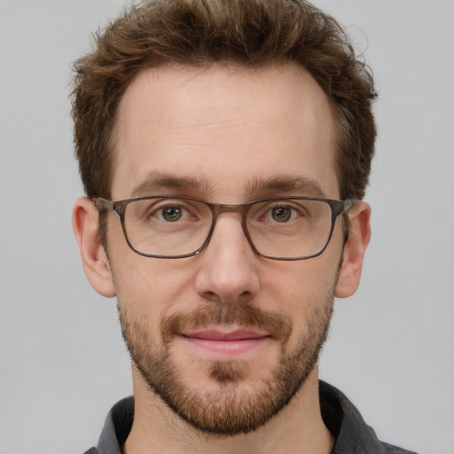 Joyful white adult male with short  brown hair and grey eyes