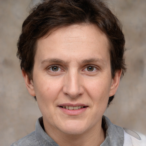 Joyful white adult female with short  brown hair and grey eyes