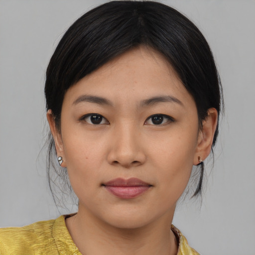 Joyful asian young-adult female with medium  brown hair and brown eyes