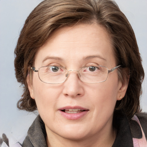 Joyful white adult female with medium  brown hair and blue eyes