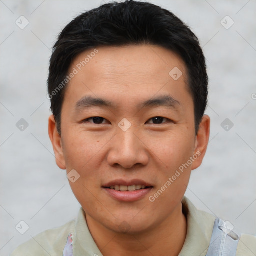 Joyful asian young-adult male with short  black hair and brown eyes