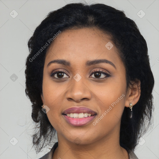 Joyful black young-adult female with long  black hair and brown eyes