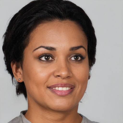 Joyful latino young-adult female with short  brown hair and brown eyes