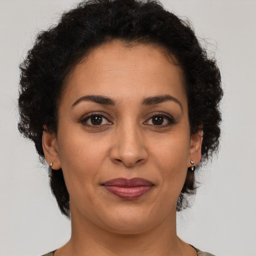 Joyful latino adult female with short  brown hair and brown eyes