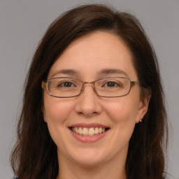 Joyful white adult female with long  brown hair and brown eyes