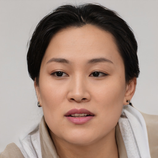 Joyful asian young-adult female with medium  brown hair and brown eyes