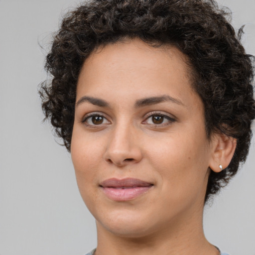Joyful white young-adult female with short  black hair and brown eyes