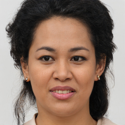 Joyful asian adult female with medium  brown hair and brown eyes