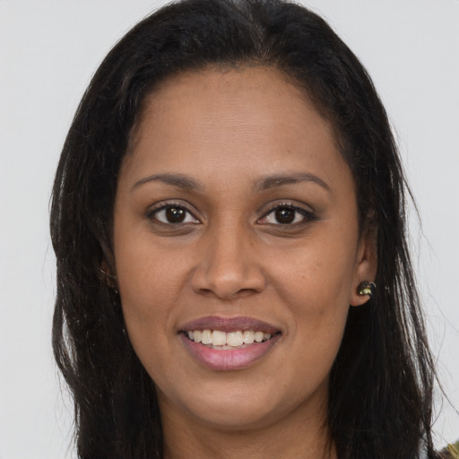 Joyful latino young-adult female with long  brown hair and brown eyes