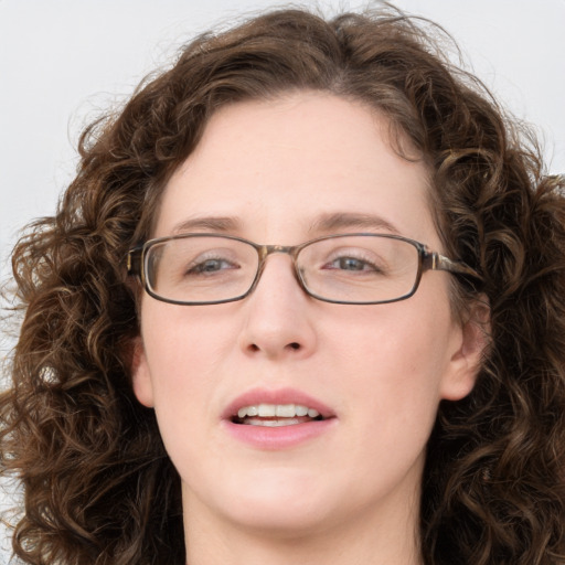 Joyful white adult female with long  brown hair and green eyes